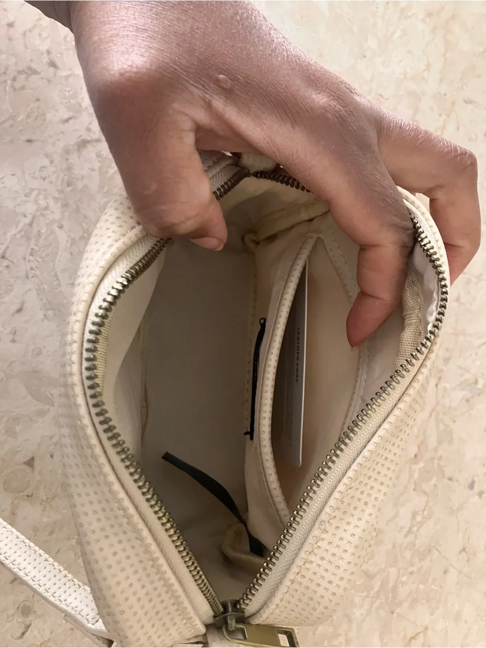 Anthropologie Cream Perforated Crossbody Camera Bag with Tassel